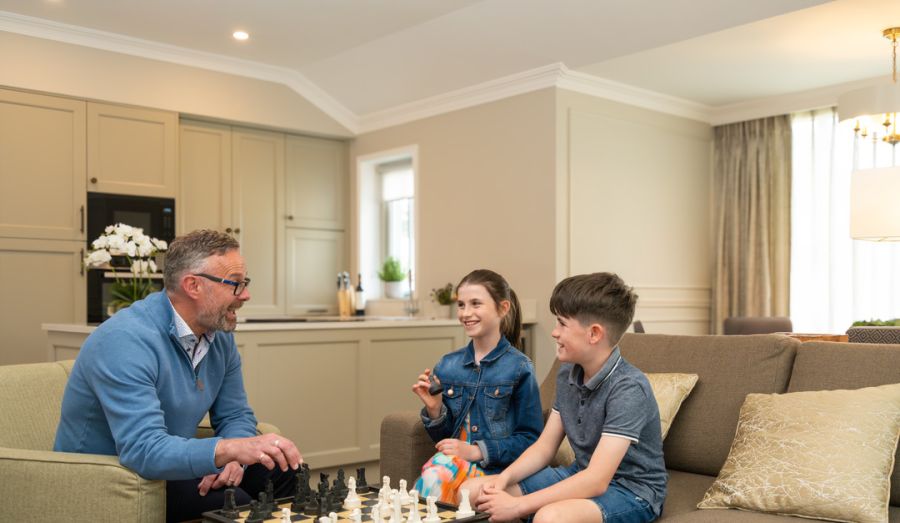 Internal The Lodges, kids playing with grandfather in the living room