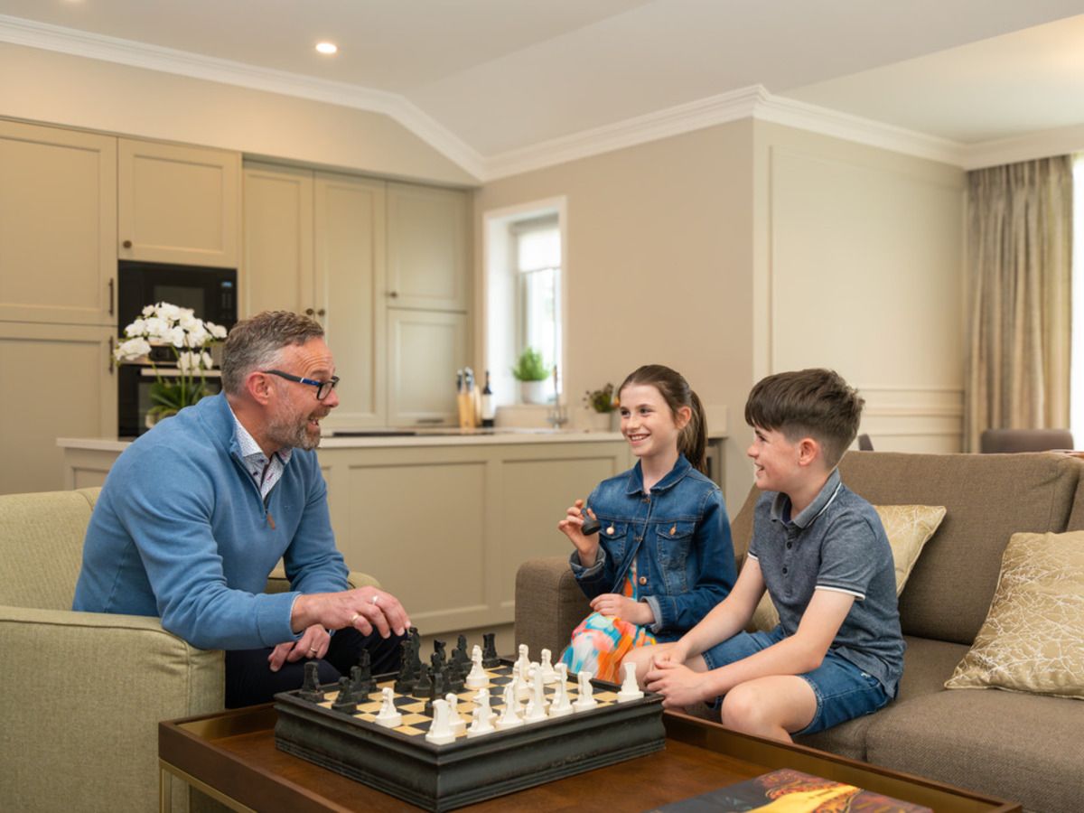 Internal The Lodges, kids playing with grandfather in the living room