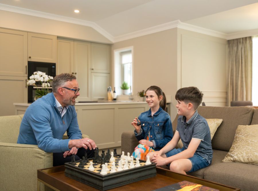 Internal The Lodges, kids playing with grandfather in the living room