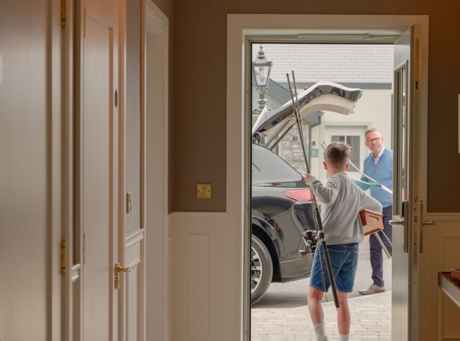 Kid with fishing rod, going to grandfather close to the car (1)