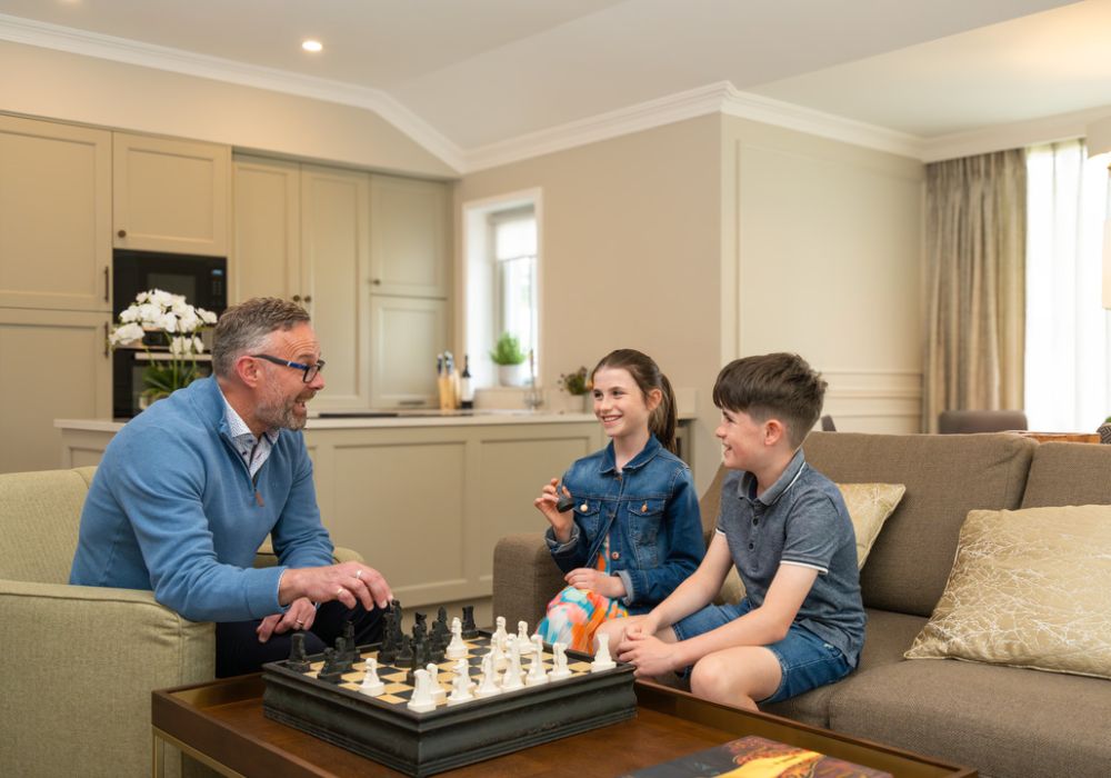 Internal The Lodges, kids playing with grandfather in the living room